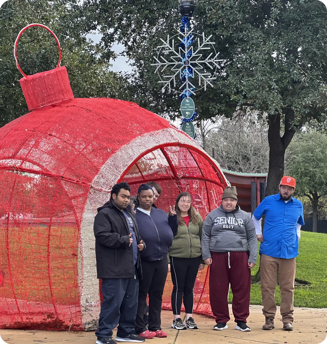Friends gathered at outdoor Christmas display